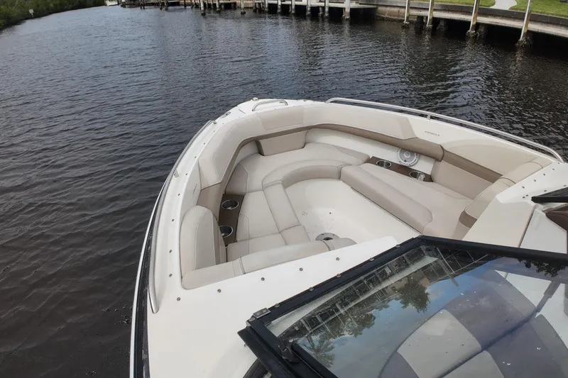 Slide: The Image of 2014 Formula 240 Bowrider boat with spacious seating on calm water. - 60