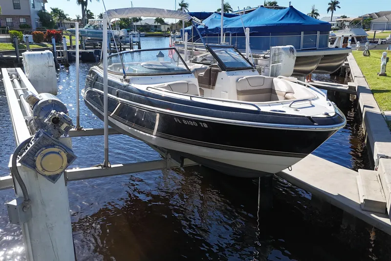 Slide: The Image of 2014 Formula 240 Bowrider boat on lift at marina dock. - 9