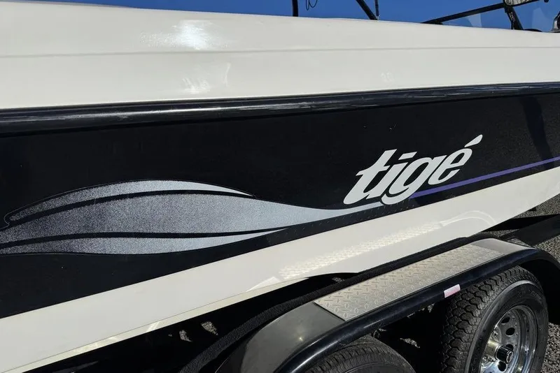 Slide: The Image of 1999 Tigé 2100V Limited boat side view with logo and design. - 11