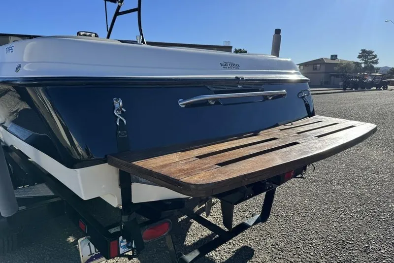 Slide: The Image of 1999 Tigé 2100V Limited boat rear view with wooden swim platform. - 16