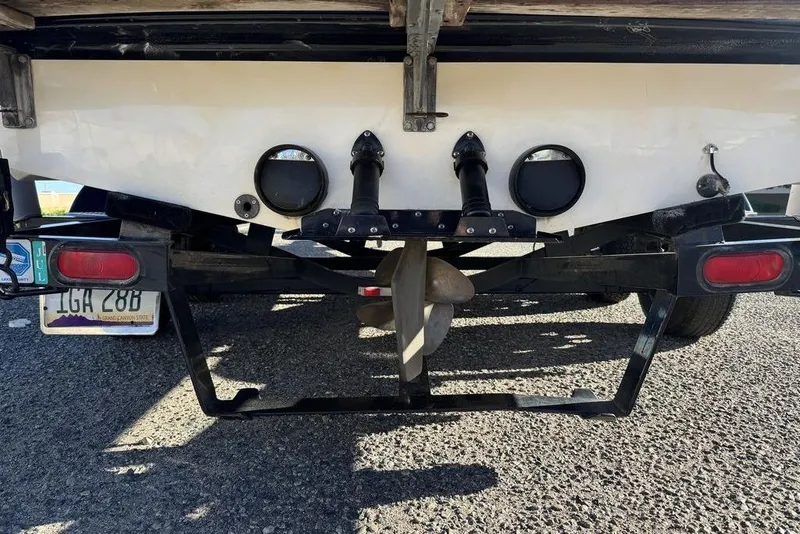 Slide: The Image of 1999 Tigé 2100V Limited boat rear view with propeller and trailer. - 17