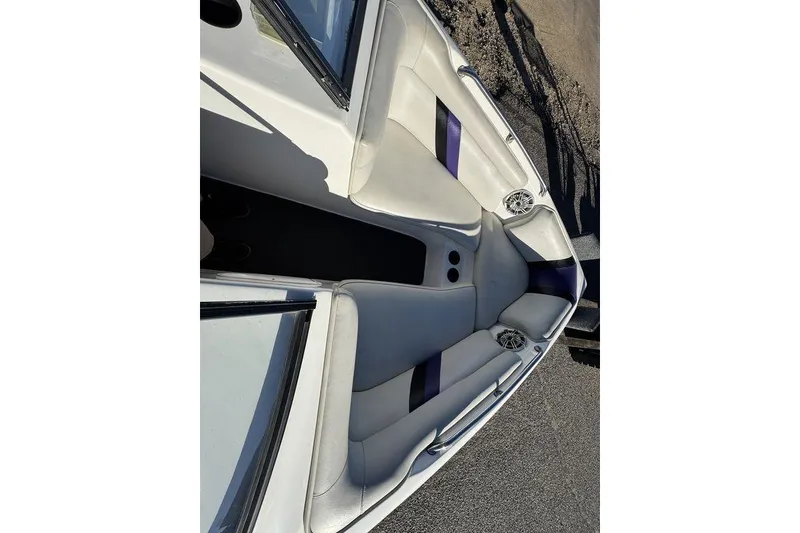 Slide: The Image of 1999 Tigé 2100V Limited boat interior with white and purple seating. - 22