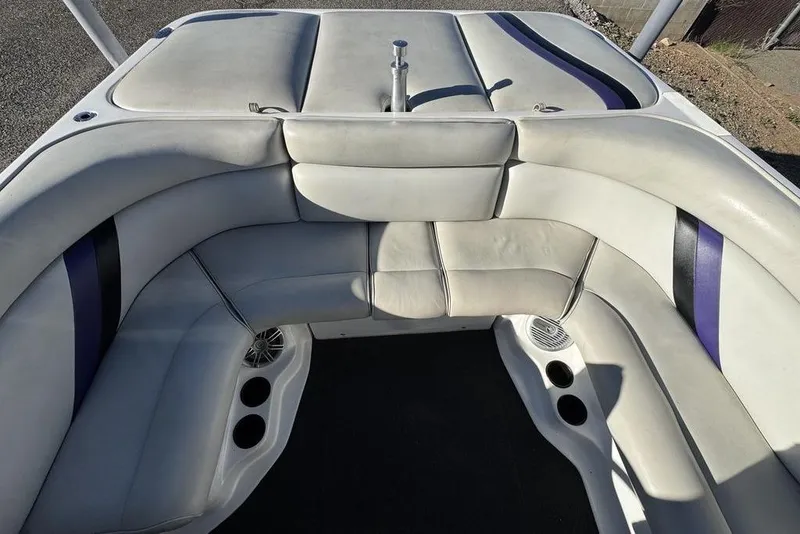 Slide: The Image of 1999 Tigé 2100V Limited boat interior with white and purple seating. - 26