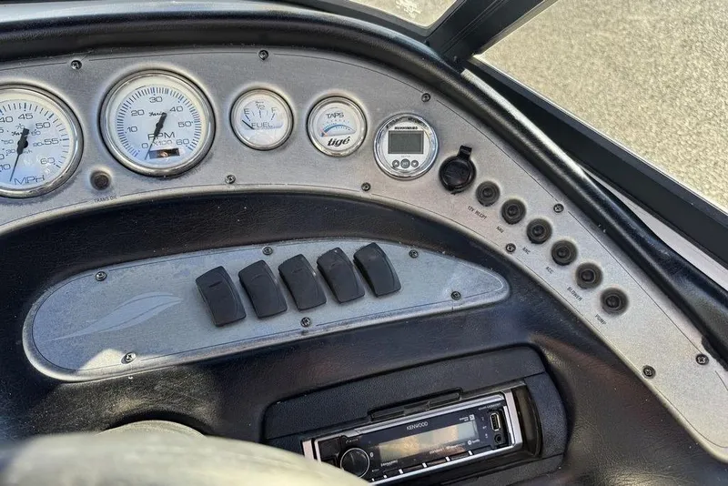Slide: The Image of Dashboard of a 1999 Tigé 2100V Limited boat with gauges and controls. - 27