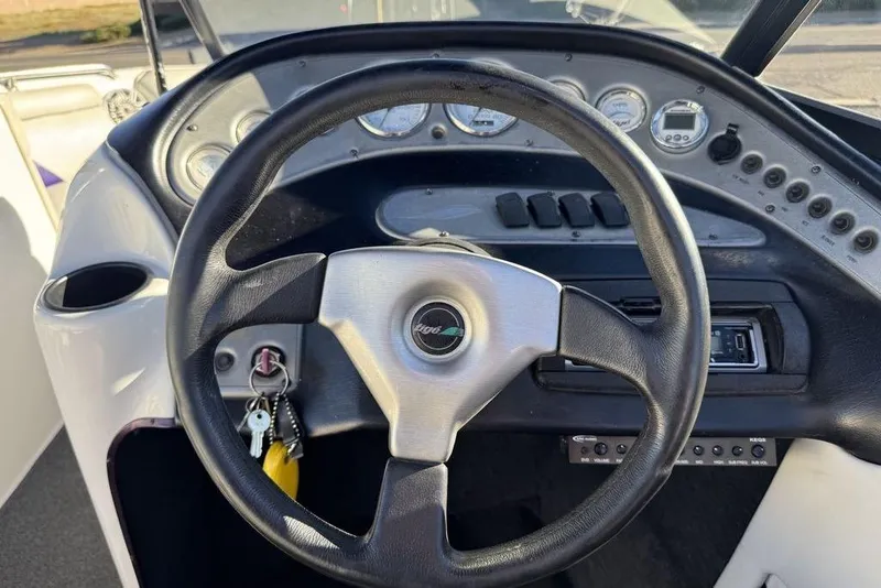 Slide: The Image of Steering wheel and dashboard of 1999 Tigé 2100V Limited boat. - 30