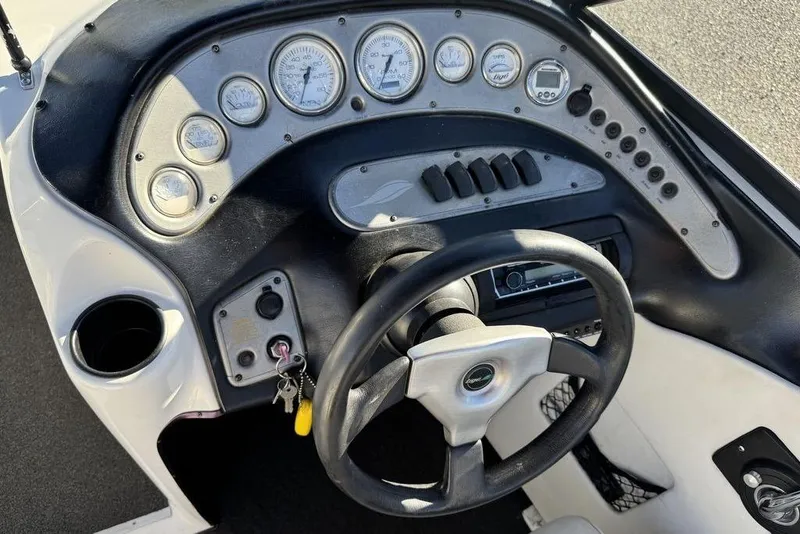 Slide: The Image of 1999 Tigé 2100V Limited boat dashboard with steering wheel and instrument panel. - 31