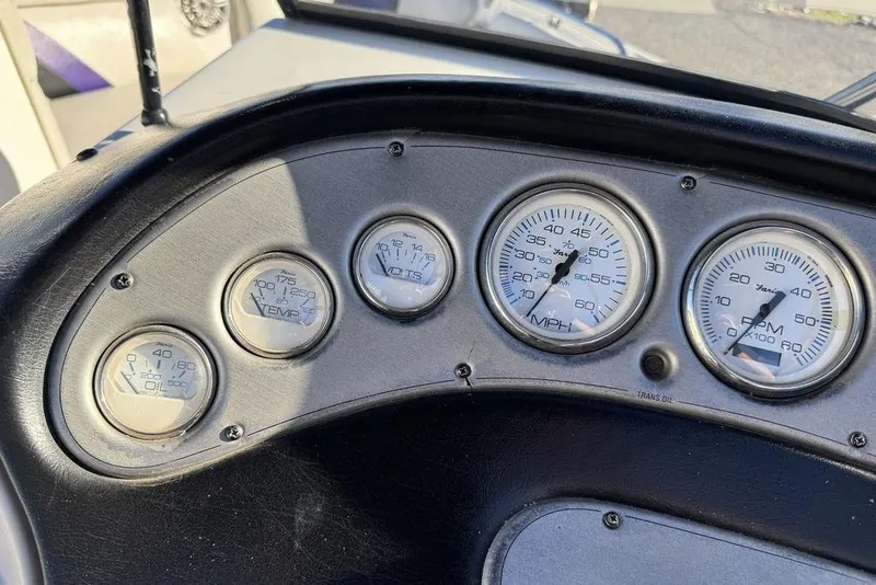 Slide: The Image of Dashboard gauges of a 1999 Tigé 2100V Limited boat, showing speed, RPM, and temperature. - 32