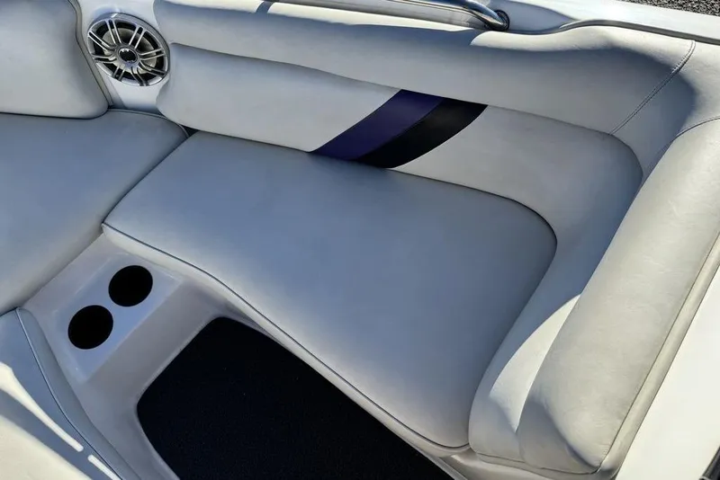 Slide: The Image of 1999 Tigé 2100V Limited boat interior with cushioned seating and cup holders. - 36