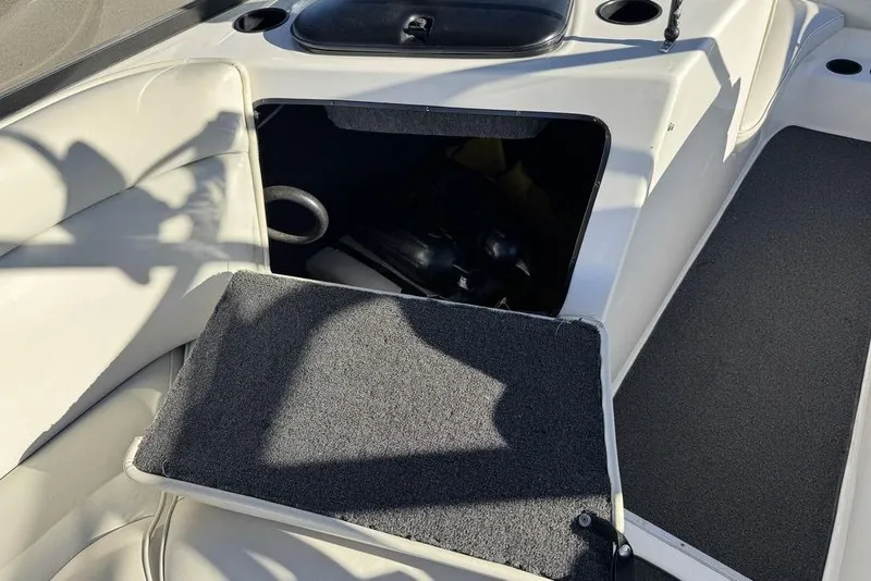 Slide: The Image of Open storage compartment on 1999 Tigé 2100V Limited boat with white seating. - 38