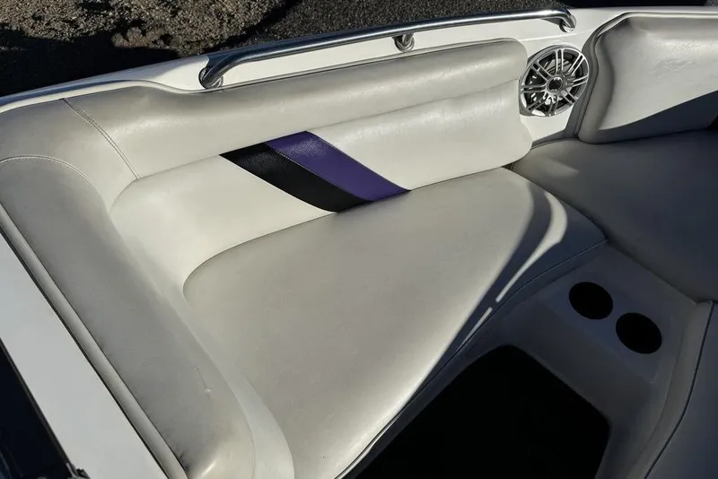 Slide: The Image of 1999 Tigé 2100V Limited boat interior with white leather seats and speaker. - 40