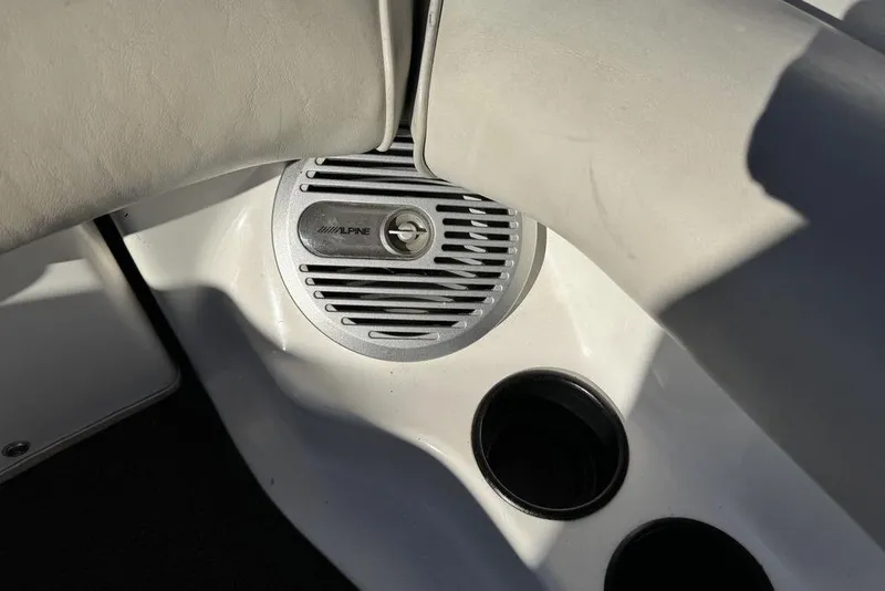 Slide: The Image of Alpine speaker and cup holder in 1999 Tigé 2100V Limited boat interior. - 43