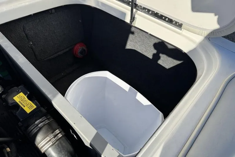Slide: The Image of Open storage compartment in 1999 Tigé 2100V Limited boat. - 44