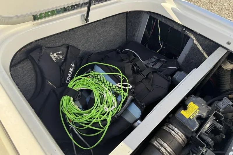 Slide: The Image of 1999 Tigé 2100V Limited boat storage with life jackets and green rope. - 45