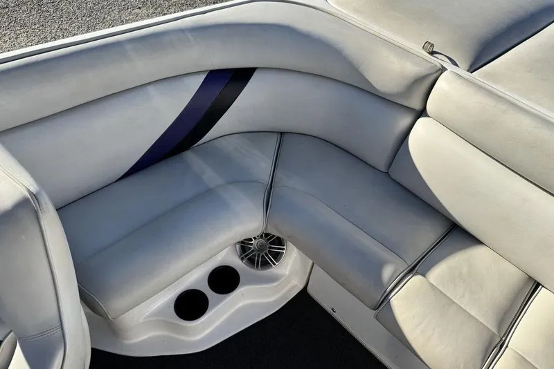 Slide: The Image of 1999 Tigé 2100V Limited boat interior with gray seating and cup holders. - 46
