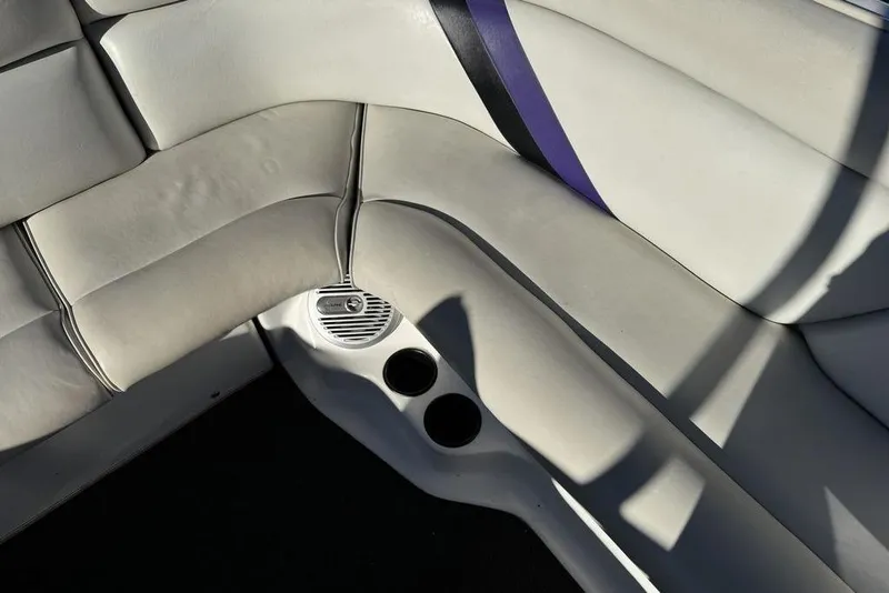 Slide: The Image of Interior seating of 1999 Tigé 2100V Limited boat with cup holders and speaker. - 49