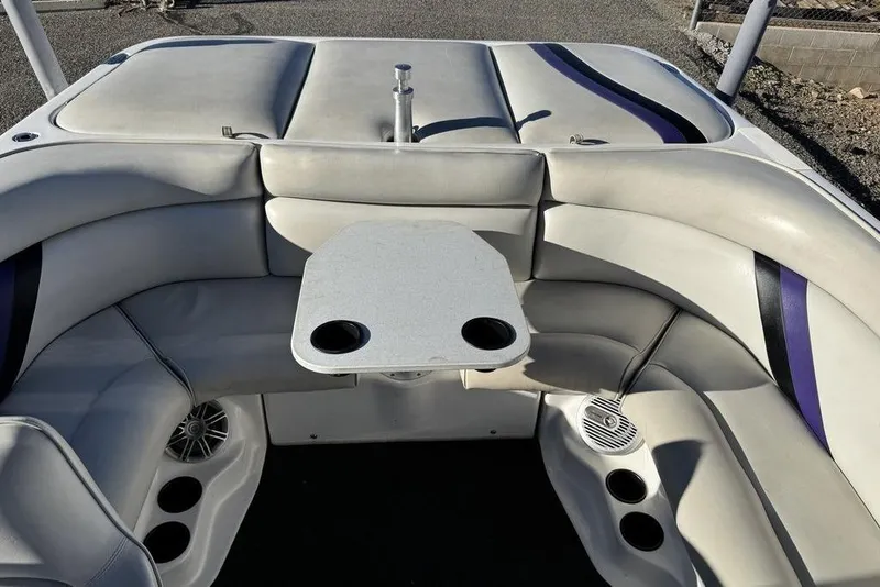 Slide: The Image of 1999 Tigé 2100V Limited boat interior with seating and table, featuring cup holders. - 51