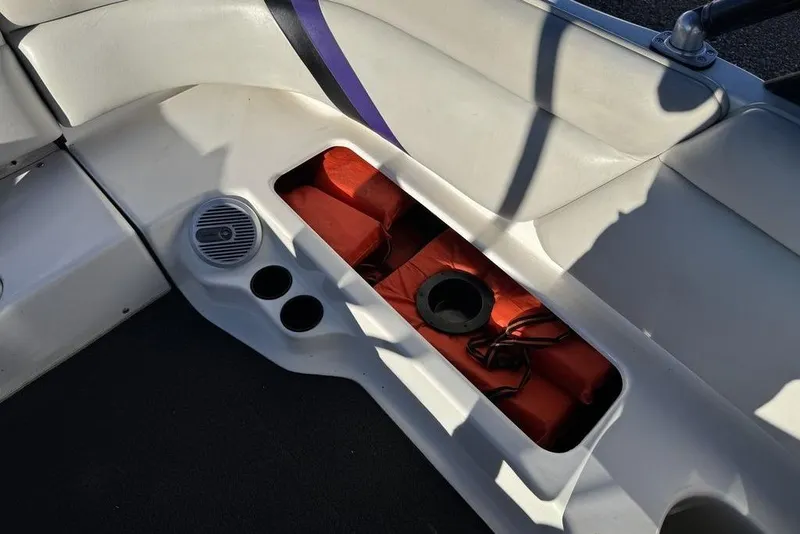 Slide: The Image of Interior of 1999 Tigé 2100V Limited boat with storage compartment and speaker. - 52