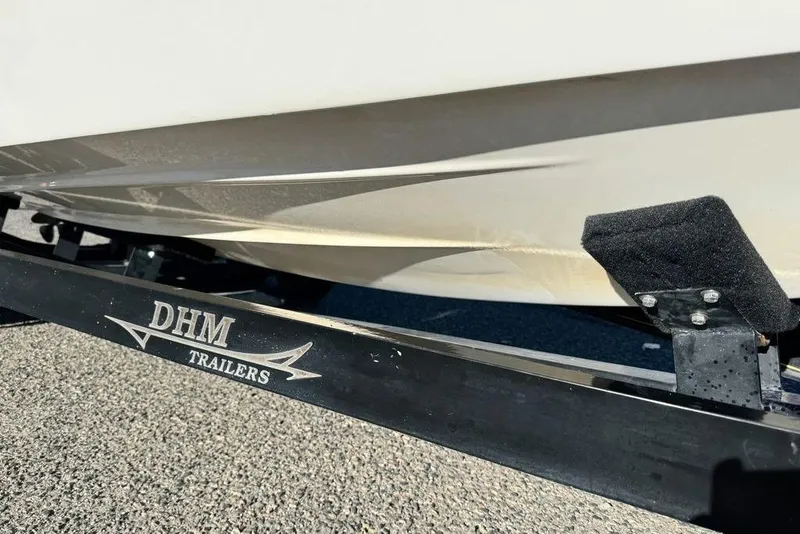 Slide: The Image of 1999 Tigé 2100V Limited boat on DHM trailer, close-up view. - 7