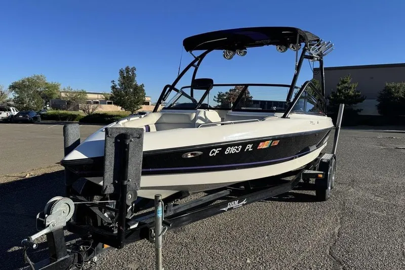 Slide: The Image of 1999 Tigé 2100V Limited boat on trailer in parking lot, sunny day. - 70