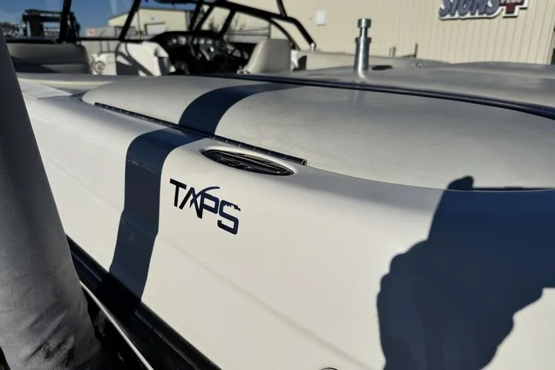 Slide: The Image of 1999 Tigé 2100V Limited boat with TAPS system, close-up view. - 73