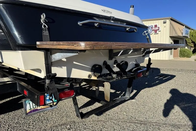 Slide: The Image of 1999 Tigé 2100V Limited boat rear view with swim platform and trailer. - 76