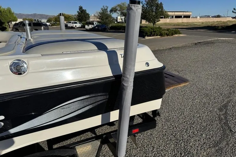 Slide: The Image of 1999 Tigé 2100V Limited boat rear view in a parking lot. - 77