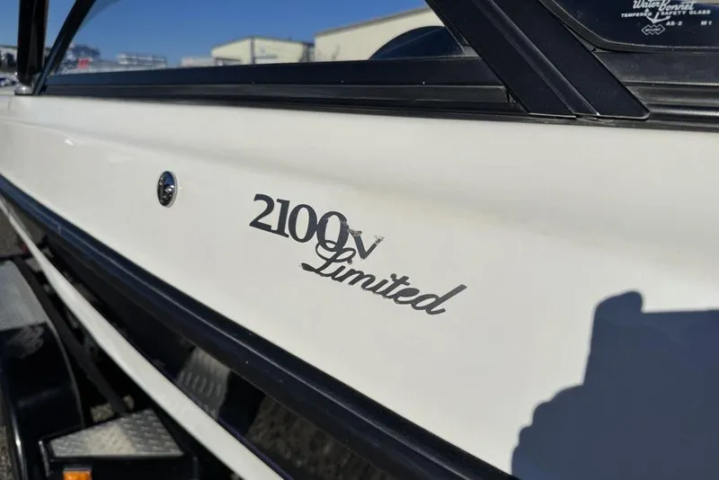 Slide: The Image of 1999 Tigé 2100V Limited boat side view with logo detail. - 8