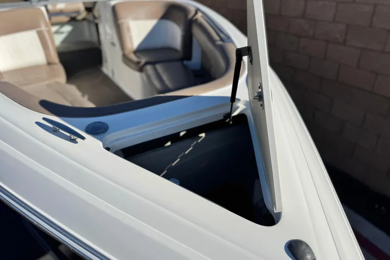 Slide: The Image of 2007 Cobalt 252 boat interior with open storage compartment and cushioned seating. - 11