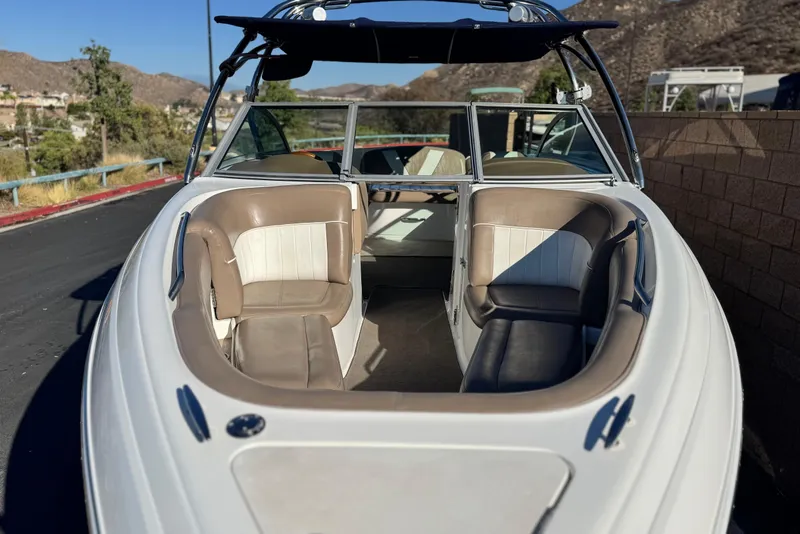 Slide: The Image of 2007 Cobalt 252 boat with beige and white interior, parked outdoors. - 12