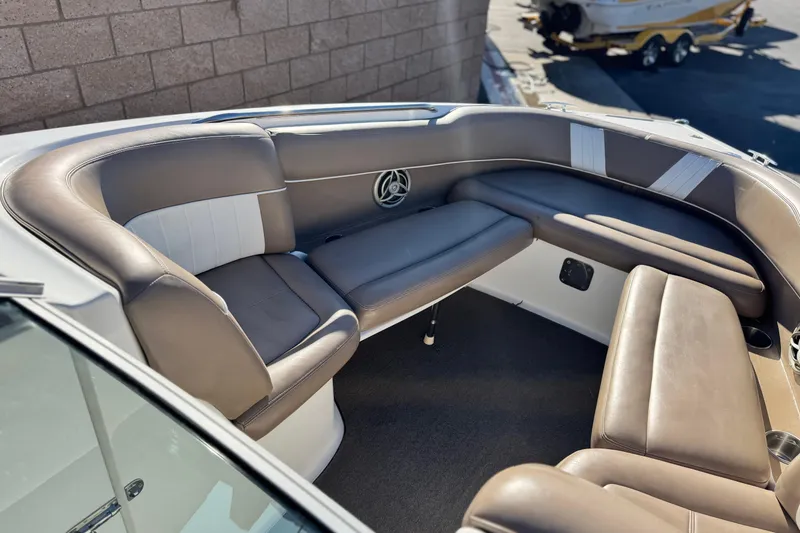 Slide: The Image of Luxurious seating area on a 2007 Cobalt 252 boat, featuring brown and white upholstery. - 14