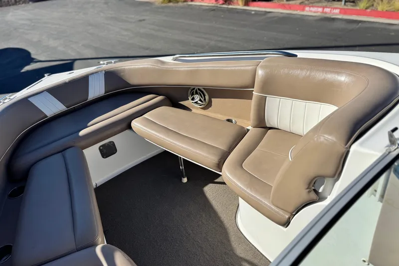Slide: The Image of 2007 Cobalt 252 boat interior with tan and white seating, showcasing luxury design. - 15