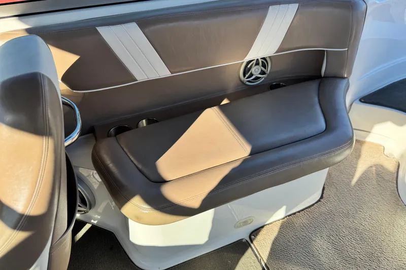 Slide: The Image of 2007 Cobalt 252 boat interior with brown leather seating and speaker detail. - 22