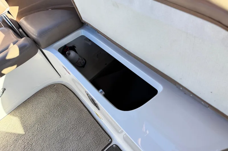 Slide: The Image of Open storage compartment in 2007 Cobalt 252 boat with fire extinguisher inside. - 25