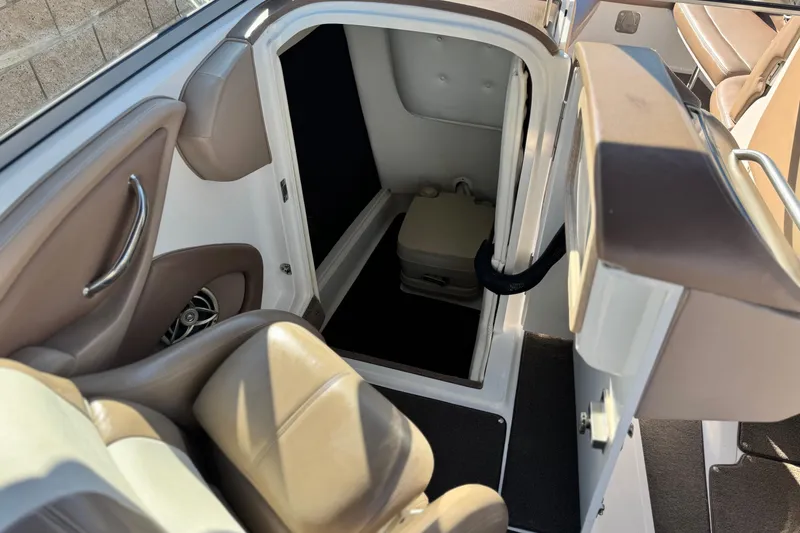 Slide: The Image of 2007 Cobalt 252 boat interior with open cabin door and seating area. - 34