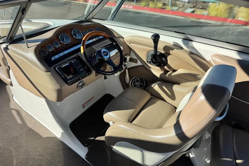 Slide: The Image of 2007 Cobalt 252 boat interior with steering wheel and control panel. - 36