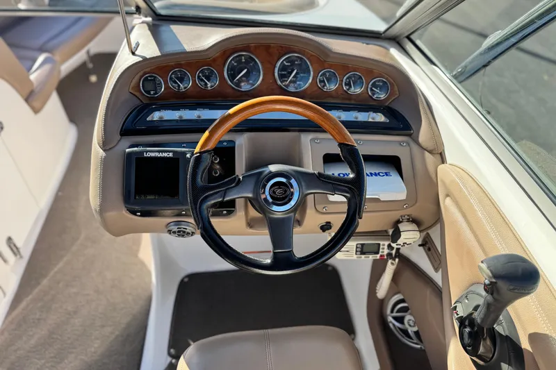 Slide: The Image of 2007 Cobalt 252 boat dashboard with steering wheel, gauges, and navigation equipment. - 37