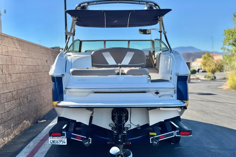 Slide: The Image of 2007 Cobalt 252 boat rear view with seating and canopy, parked outdoors. - 4