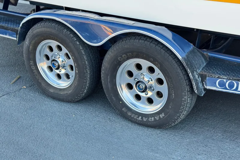 Slide: The Image of Trailer wheels of a 2007 Cobalt 252 boat on a paved surface. - 41