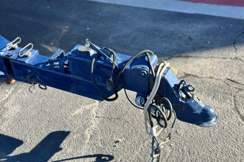 Slide: The Image of Trailer hitch of a 2007 Cobalt 252 boat, featuring blue metal and cables. - 42
