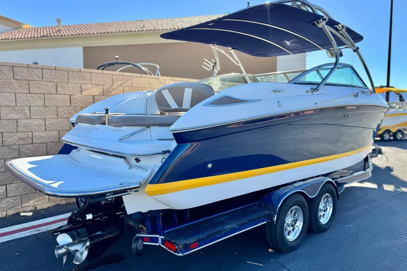 Slide: The Image of 2007 Cobalt 252 boat with blue and yellow accents on a trailer. - 5