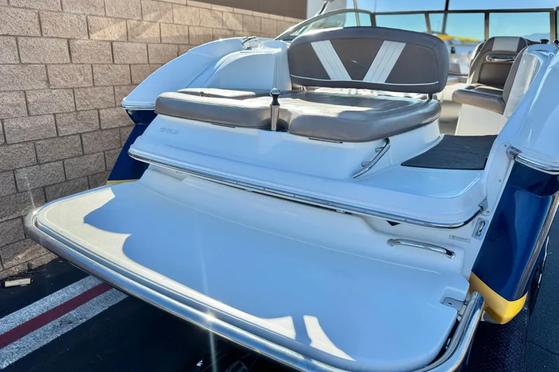 Slide: The Image of 2007 Cobalt 252 boat with rear seating and swim platform, parked near a brick wall. - 6