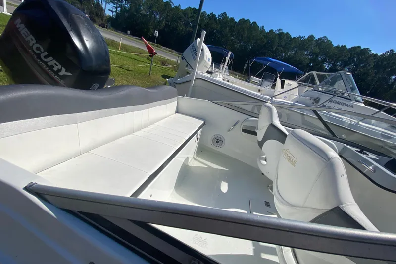 Slide: The Image of 2016 Caravelle 16 EBo boat interior with seating and Mercury outboard motor. - 10