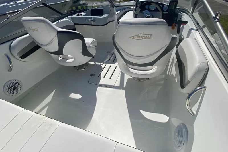 Slide: The Image of Interior of a 2016 Caravelle 16 EBo boat with white seating and steering console. - 6