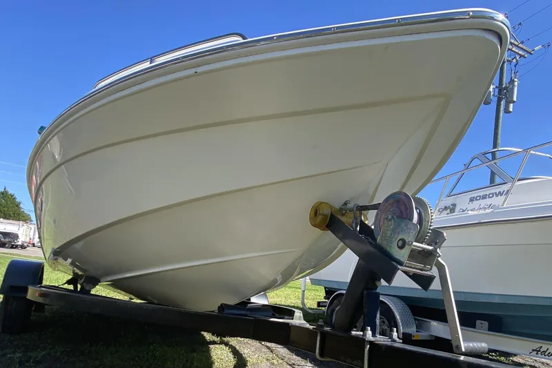 Slide: The Image of 2016 Caravelle 16 EBo boat on trailer, viewed from the front, under clear blue sky. - 8