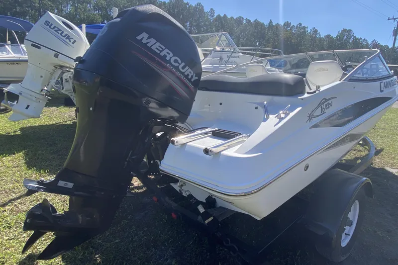 Slide: The Image of 2016 Caravelle 16 EBo boat with Mercury outboard motor on a trailer. - 4