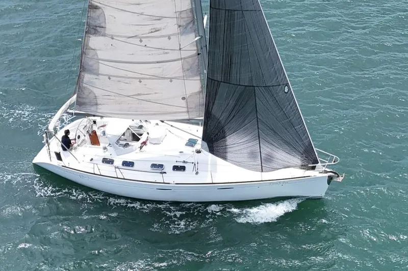 The Image of 1996 Beneteau First 42s7 sailboat navigating ocean waters under clear skies. - 0