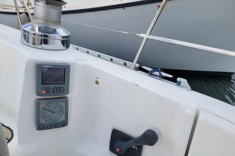 Slide: The Image of 1996 Beneteau First 42s7 yacht cockpit with winches, ropes, and teak seating. - 12