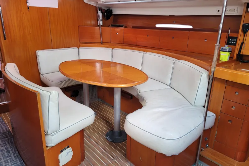 Slide: The Image of 1996 Beneteau First 42s7 sailboat deck with ropes and winches in a marina setting. - 30