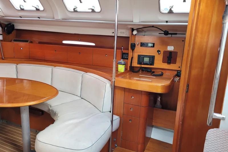 Slide: The Image of Interior of 1996 Beneteau First 42s7 yacht with cozy seating and wooden table. - 32