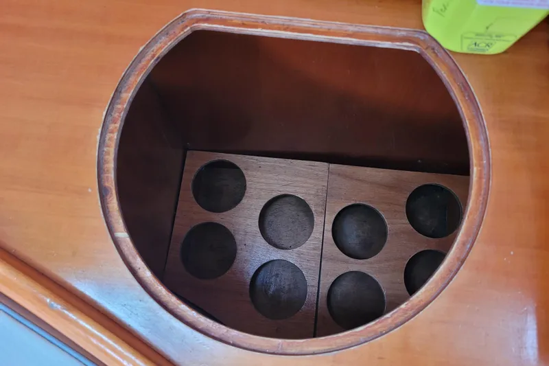 Slide: The Image of Interior of 1996 Beneteau First 42s7 yacht, featuring a wooden galley and seating area. - 33